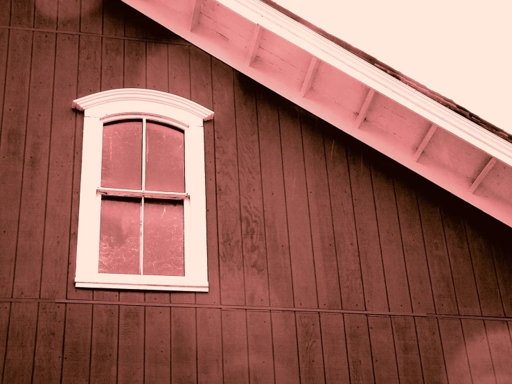 there is a window with shutters on the side of the house