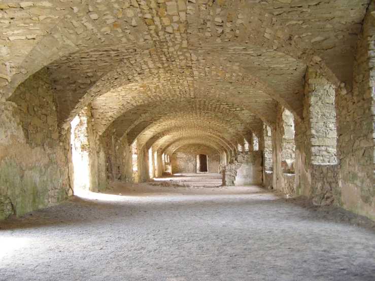 an old and empty tunnel with a walkway between it