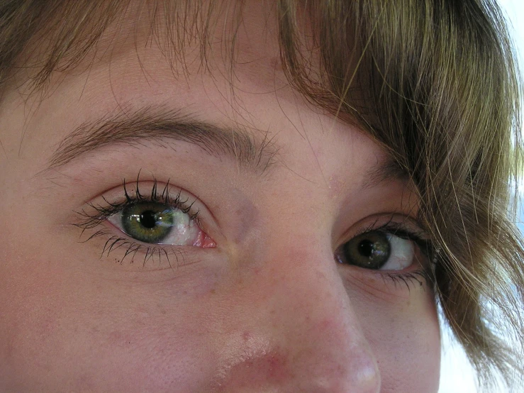 a close up of a woman with eyeliners on her face