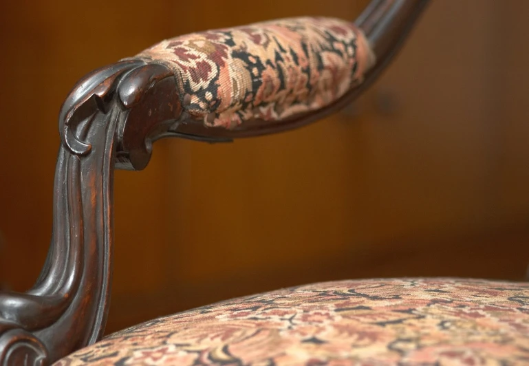 a chair with a floral print back and arm