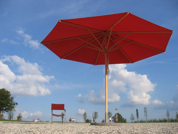 an umbrella and chairs sitting on the beach