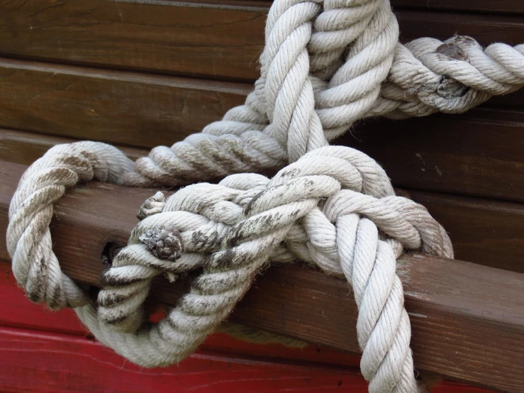 several ropes are wrapped around and hanging from a building