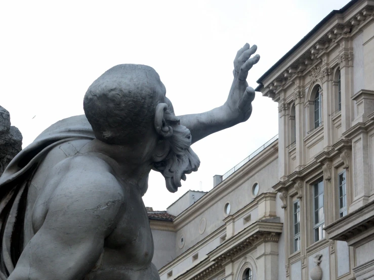 a statue of a person holding their hand out with both hands