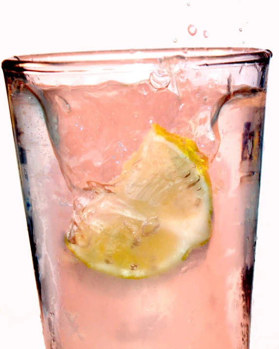 a glass full of ice and lemon with water