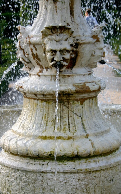 there is water being gushing from the base of this statue