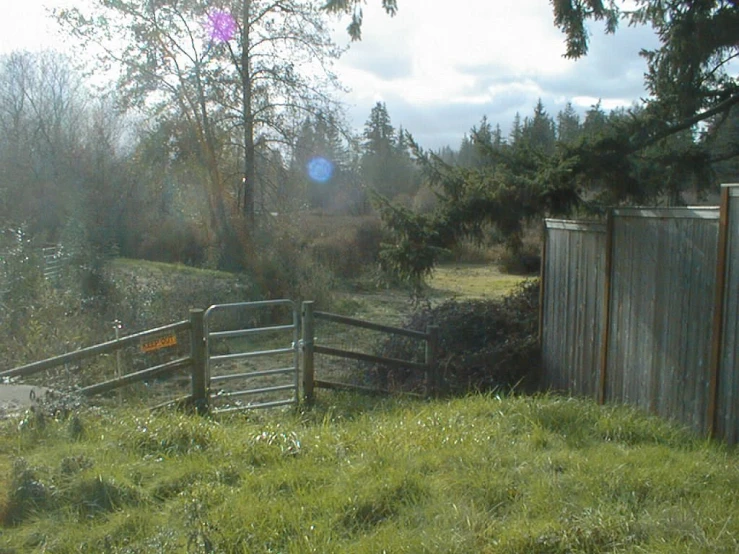 a gate on a green hill with grass below