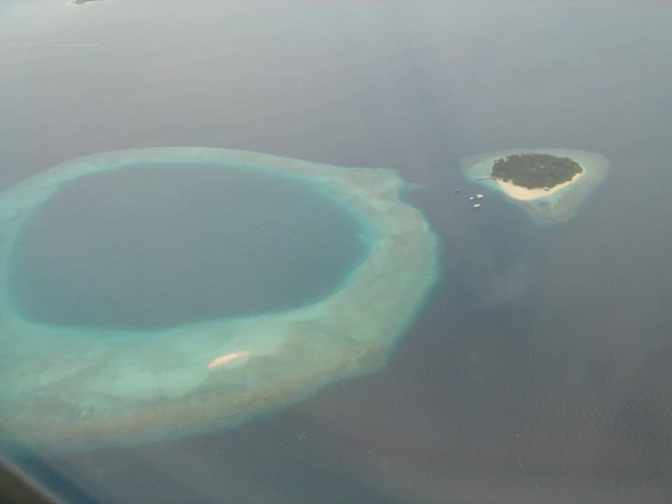 an island seen from a plane on the ocean
