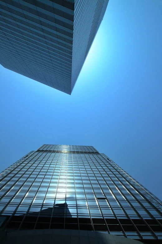 a tall building in the middle of a blue sky