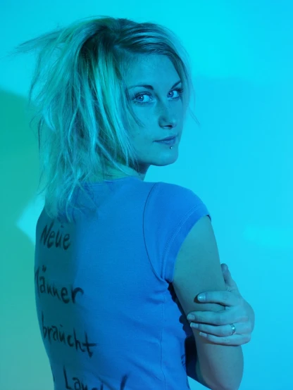 a woman wearing a blue shirt with words on it
