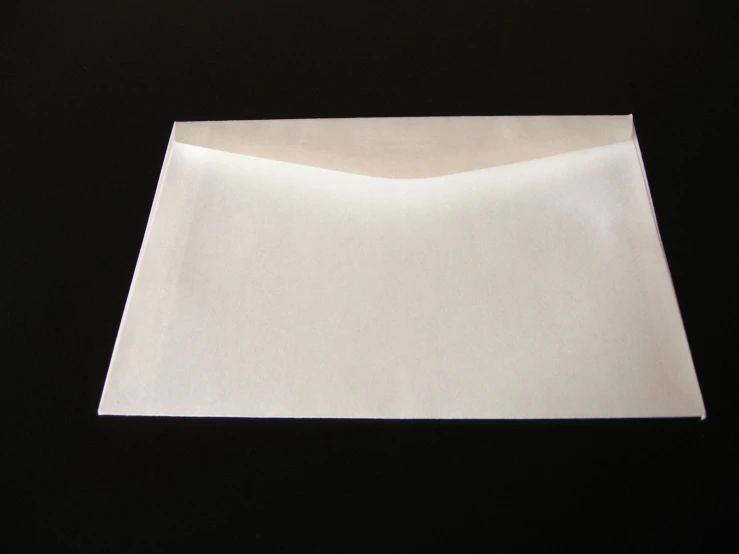 a white folded piece of paper sitting on top of a table