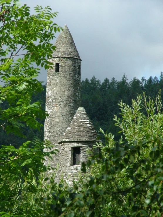 a gray tower with a roof that appears to be a castle