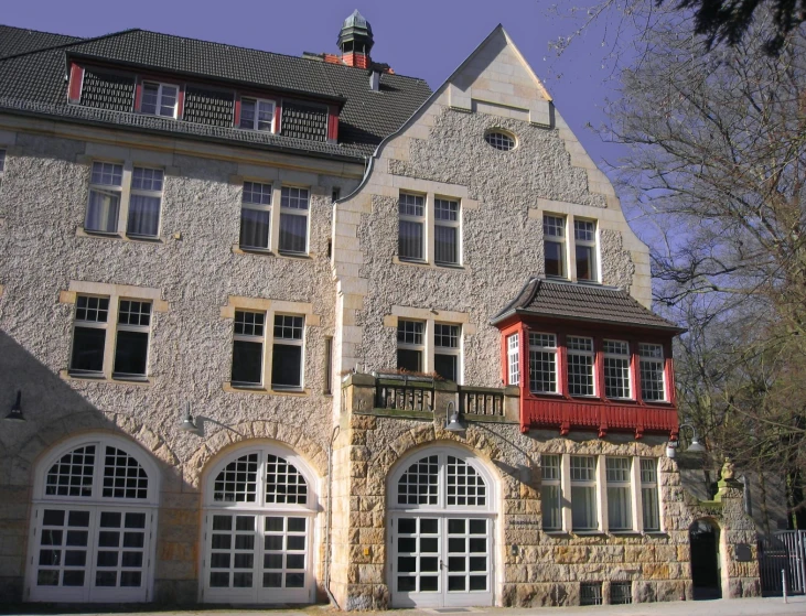 two story house with three doors and a balcony