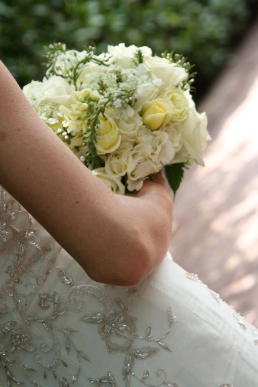 a bridal holding a bouquet of flowers in her hand