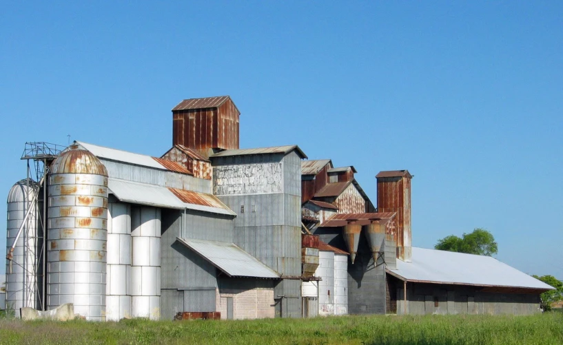 old weathered grain mill with a blue sky background