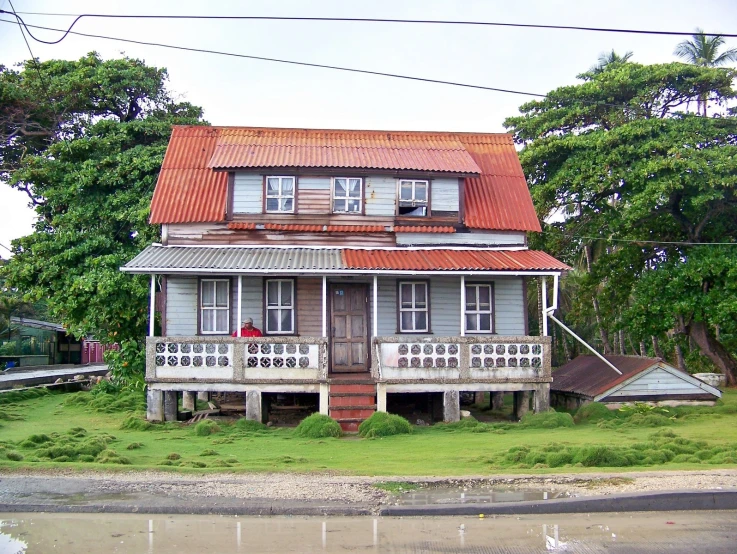 an old house sitting next to a lake