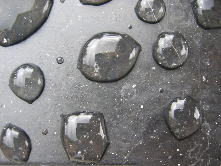 several water drops and their reflection in a mirror