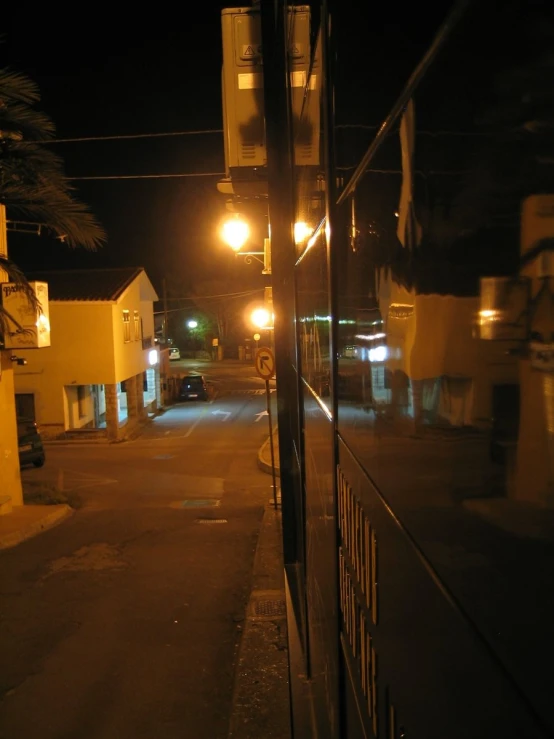 the view of a street with buildings through a glass ceiling