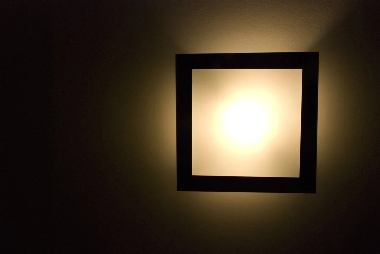 a square light is shining through the darkness