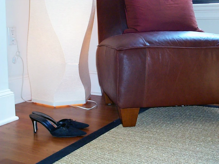 a pair of black high heel shoes laying on the floor