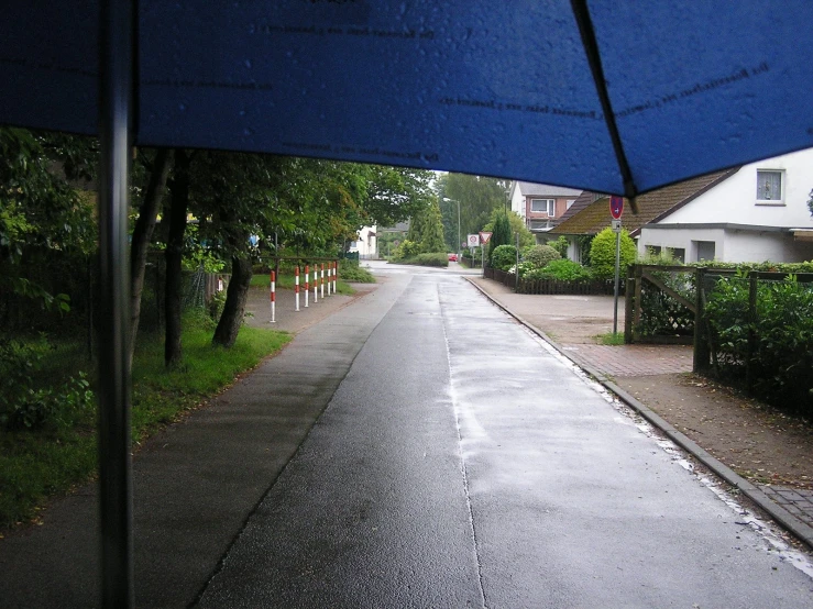 an umbrella hanging above a flooded street