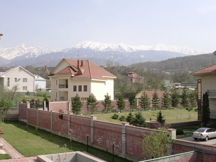 a couple of small white buildings next to mountains