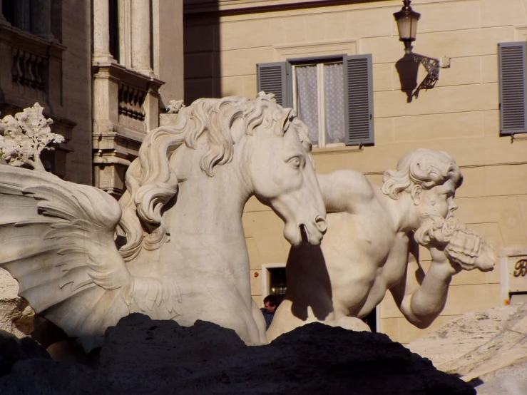 the statues are standing outside a large building