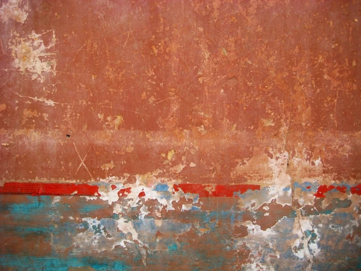 an old wall with chipped paint, red with blue lines and white paint