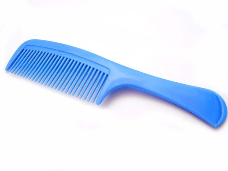 a blue comb sits on a white surface