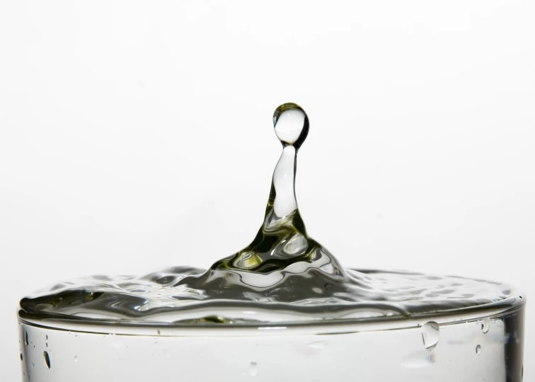 a water drop falling down into a bowl