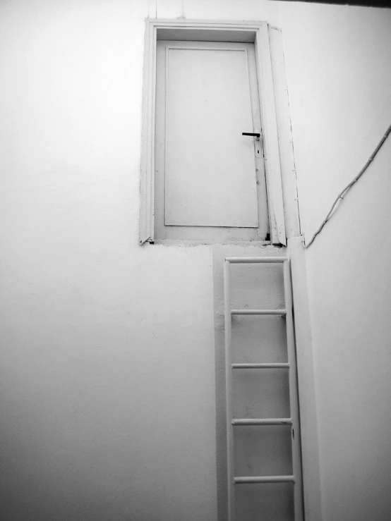 a ladder and door are shown near a wall