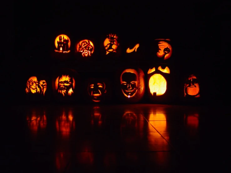 pumpkin carvings in a black room decorated with pumpkin carving