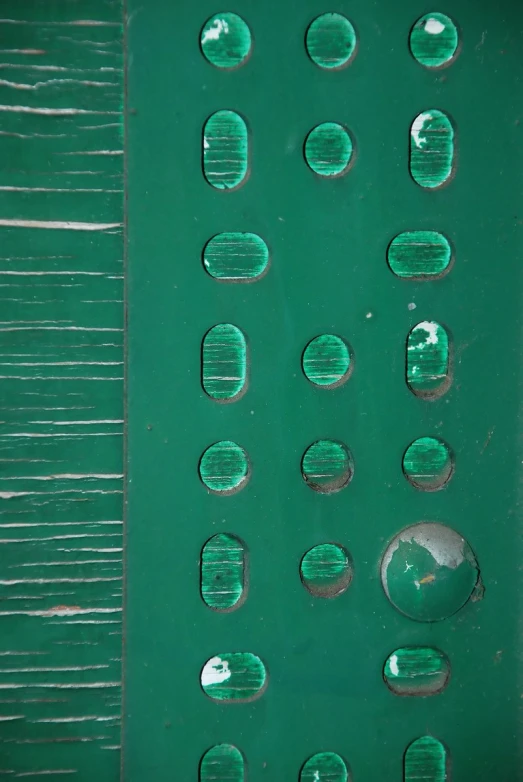 a group of different green bubbles on a piece of plastic