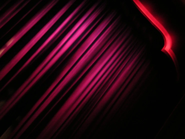 a dark theater stage with red curtains