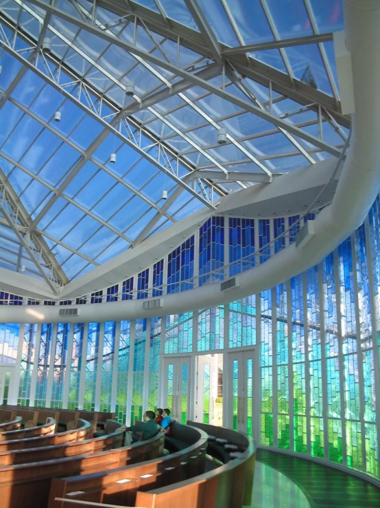 a large church with lots of windows and wooden pews