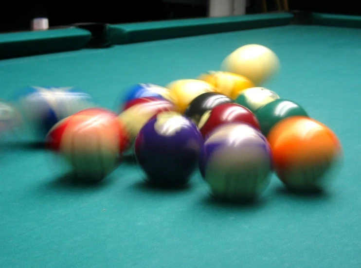 pool balls sitting on top of a green pool table