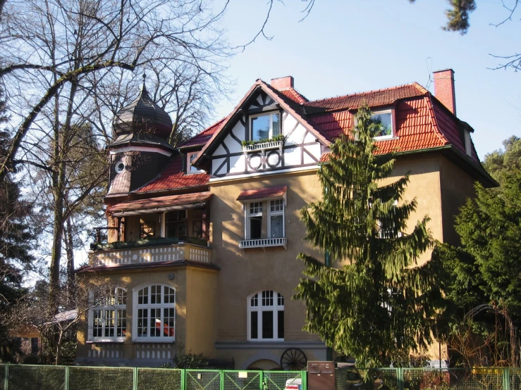 a big yellow building with a red roof