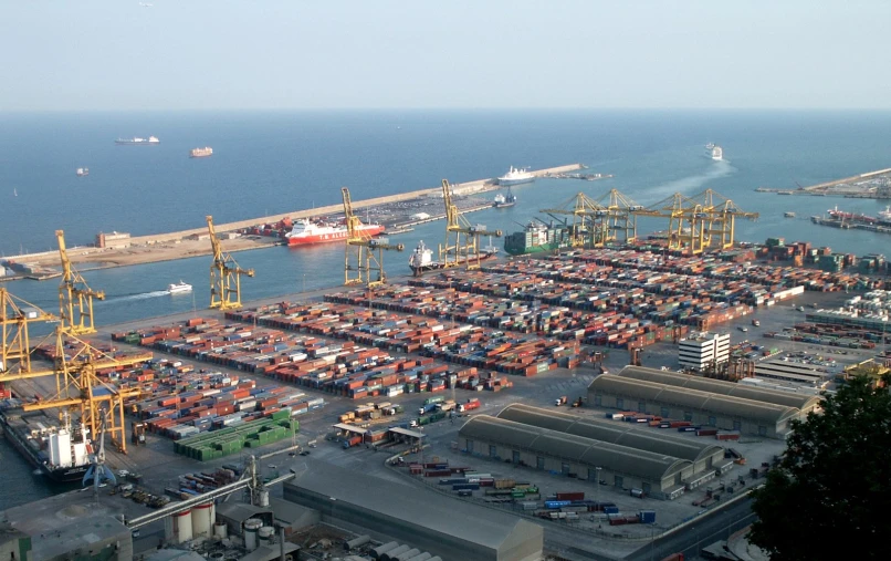 an aerial view of an ocean port with lots of cargo