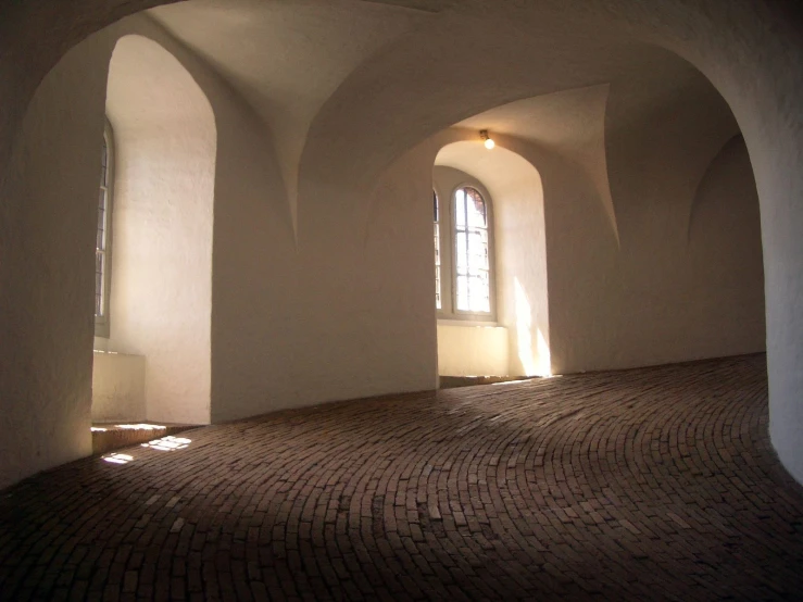 a large room that has arched windows on the walls