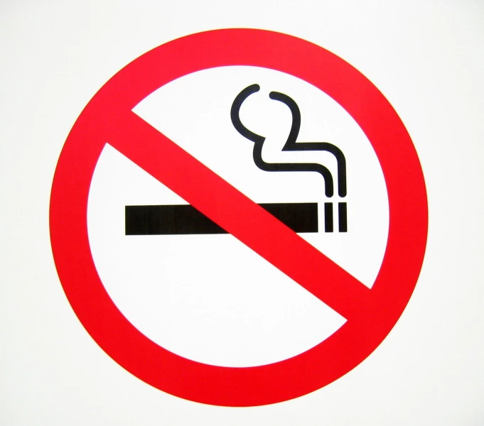 a close up of a red sign with a cigarette in it