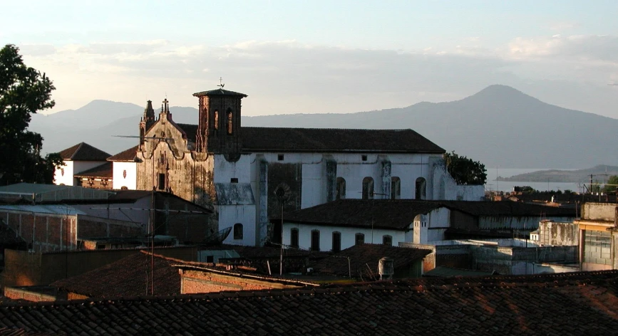 an old church with a view of a mountain range