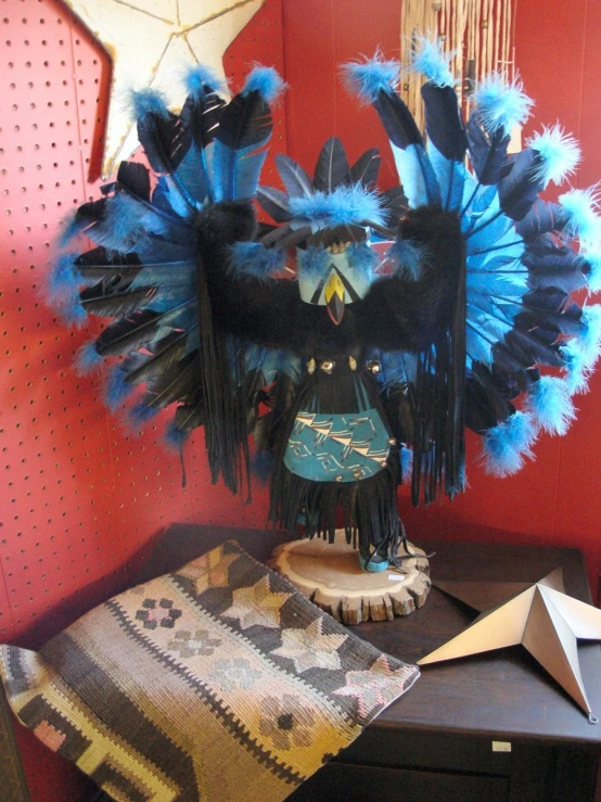 a wooden table topped with a blue and black eagle sculpture