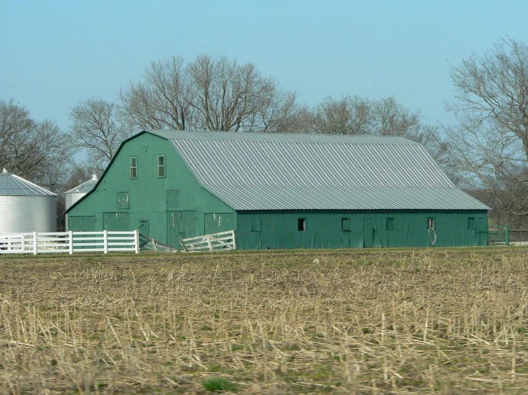 a farm house is in an open field of grass