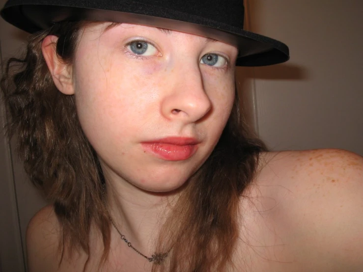 a person with a black hat is staring into the camera