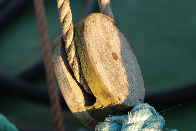 a piece of wood is hanging by a rope