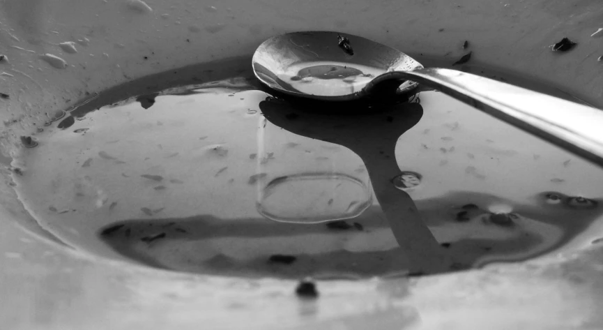 an old spoon is shown in the water