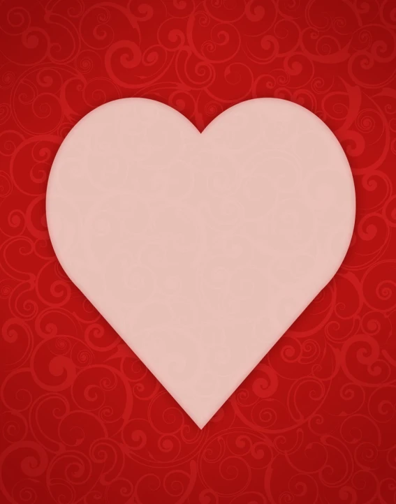 a pink paper heart on a red background