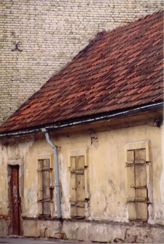 a very old white building with a red roof
