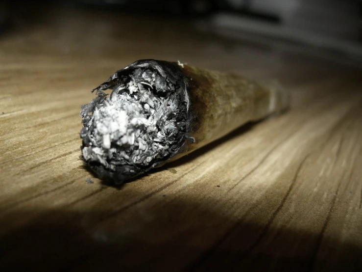 a piece of tin foil is sitting on a wood table