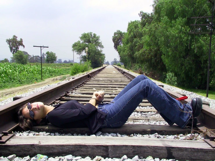 an image of a man laying on train tracks