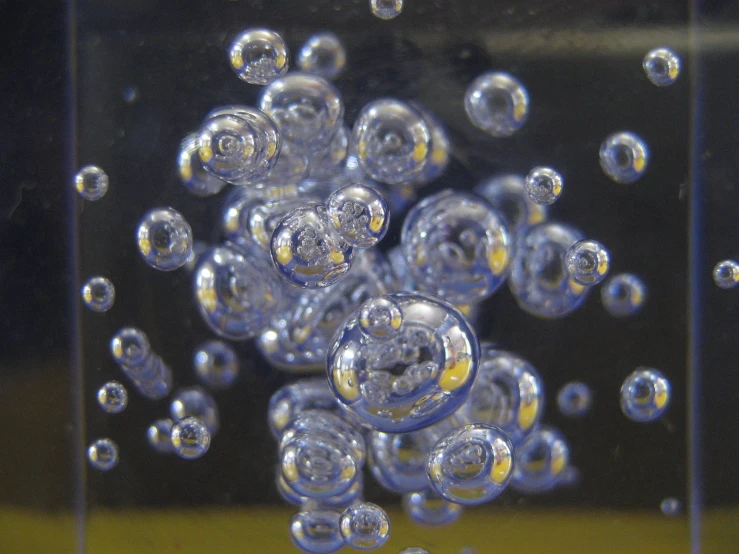 the bubbles and rims of this clear object are reflecting off of a large square